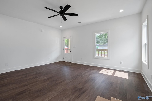 unfurnished room with dark hardwood / wood-style floors and ceiling fan