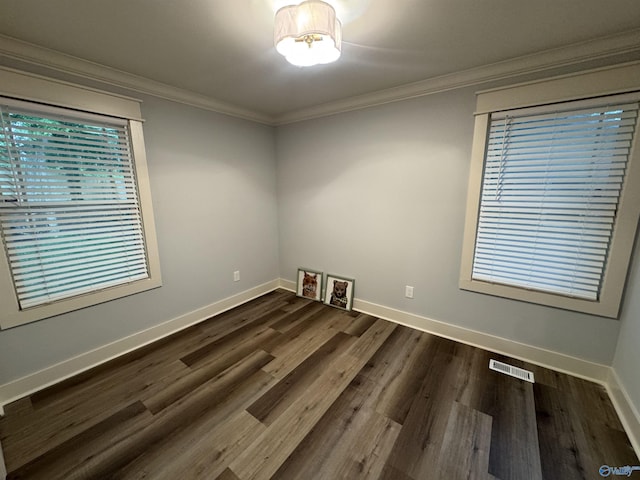 2205 Euclid Rd, Huntsville, AL 35810 - unfurnished room with dark wood-style flooring, crown molding, and baseboards