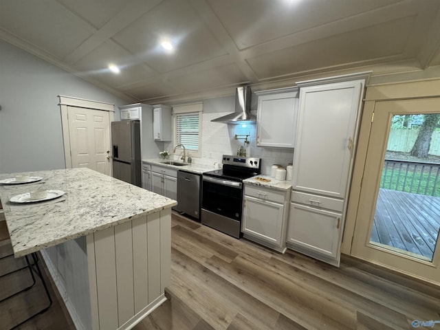 2205 Euclid Rd, Huntsville, AL 35810 - kitchen with stainless steel appliances, wall chimney exhaust hood, a sink, wood finished floors, and backsplash