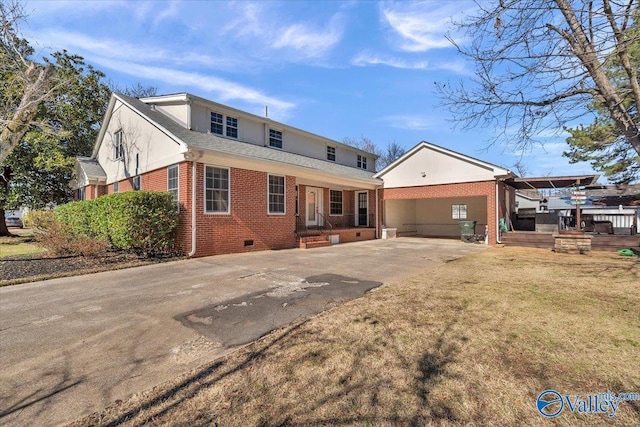 rear view of house with a yard and a carport