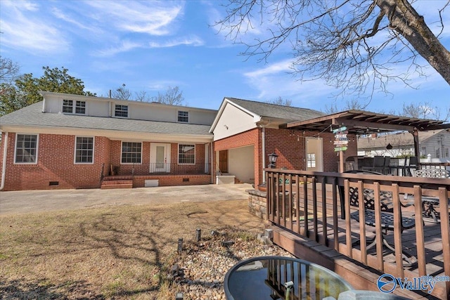 back of house with a wooden deck and a garage