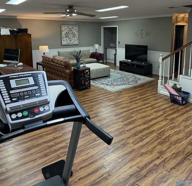 living room featuring crown molding, hardwood / wood-style floors, and ceiling fan