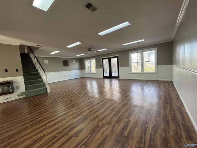 unfurnished living room featuring heating unit, crown molding, dark hardwood / wood-style flooring, and plenty of natural light