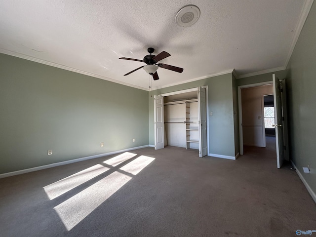 unfurnished bedroom featuring carpet, ornamental molding, a textured ceiling, ceiling fan, and a closet