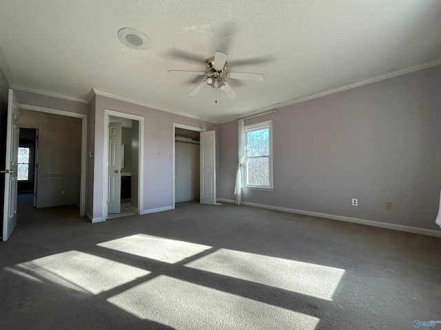 unfurnished bedroom with a textured ceiling, dark carpet, ceiling fan, and crown molding