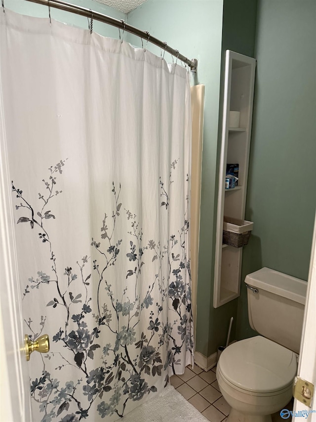 bathroom with toilet, a textured ceiling, tile patterned floors, and curtained shower