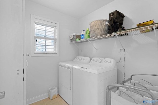 laundry area featuring light tile patterned floors and washer and dryer