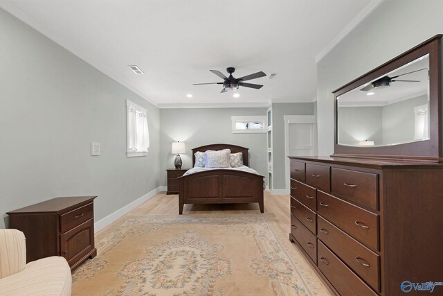 bedroom featuring ceiling fan, crown molding, and light hardwood / wood-style flooring