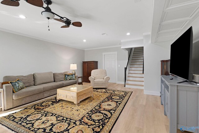 living room featuring ceiling fan, ornamental molding, and light hardwood / wood-style flooring