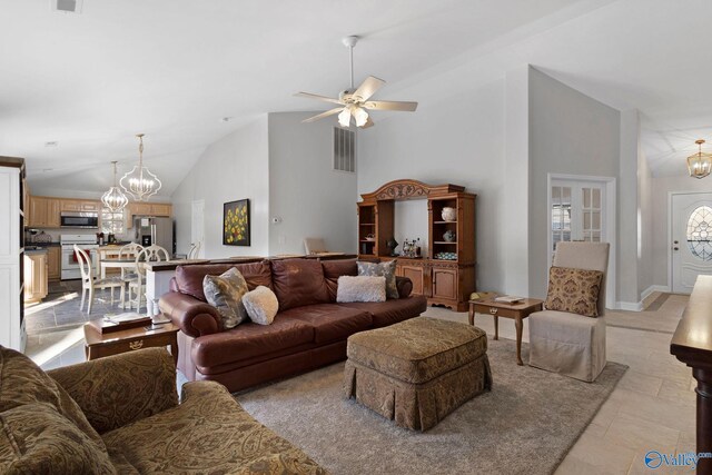 living room with lofted ceiling and ceiling fan with notable chandelier