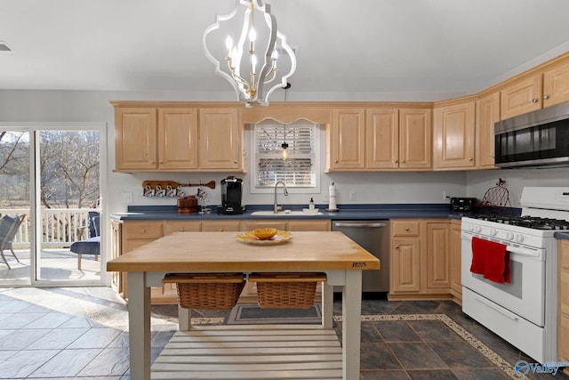 kitchen with sink, an inviting chandelier, hanging light fixtures, appliances with stainless steel finishes, and light brown cabinets