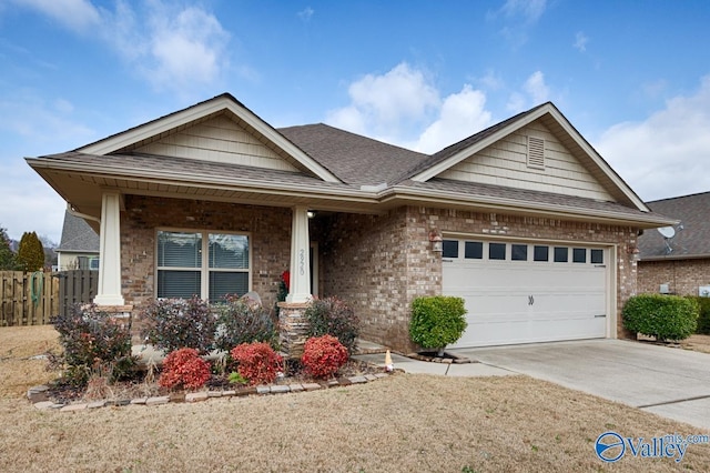 view of front of home with roof with shingles, brick siding, an attached garage, fence, and driveway