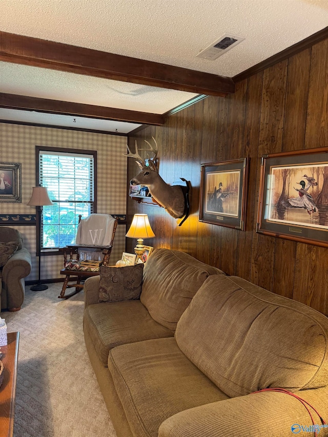 carpeted living room with beamed ceiling, a textured ceiling, and wood walls