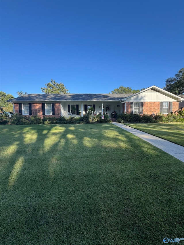 ranch-style home with a front lawn