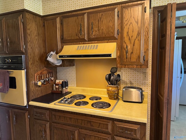 kitchen with extractor fan and white appliances