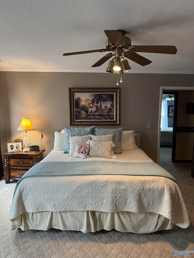 carpeted bedroom featuring a textured ceiling, ceiling fan, and crown molding