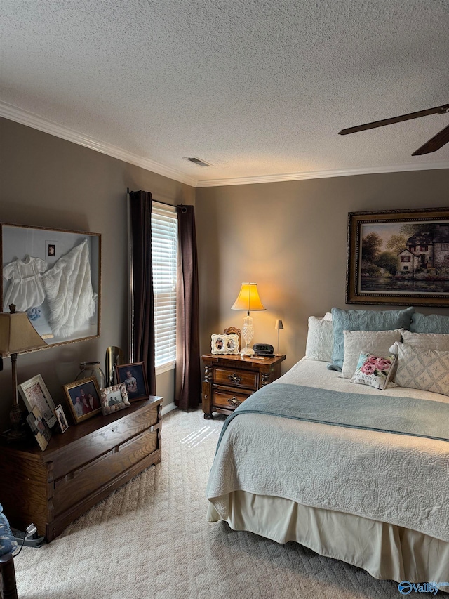 carpeted bedroom featuring ceiling fan, crown molding, and a textured ceiling