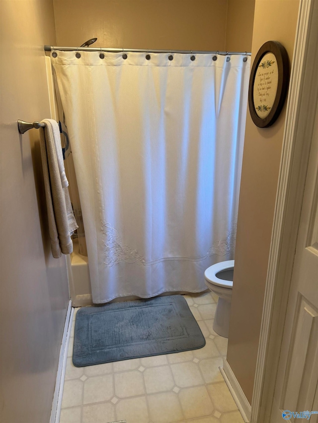 bathroom with toilet and shower / bath combo with shower curtain