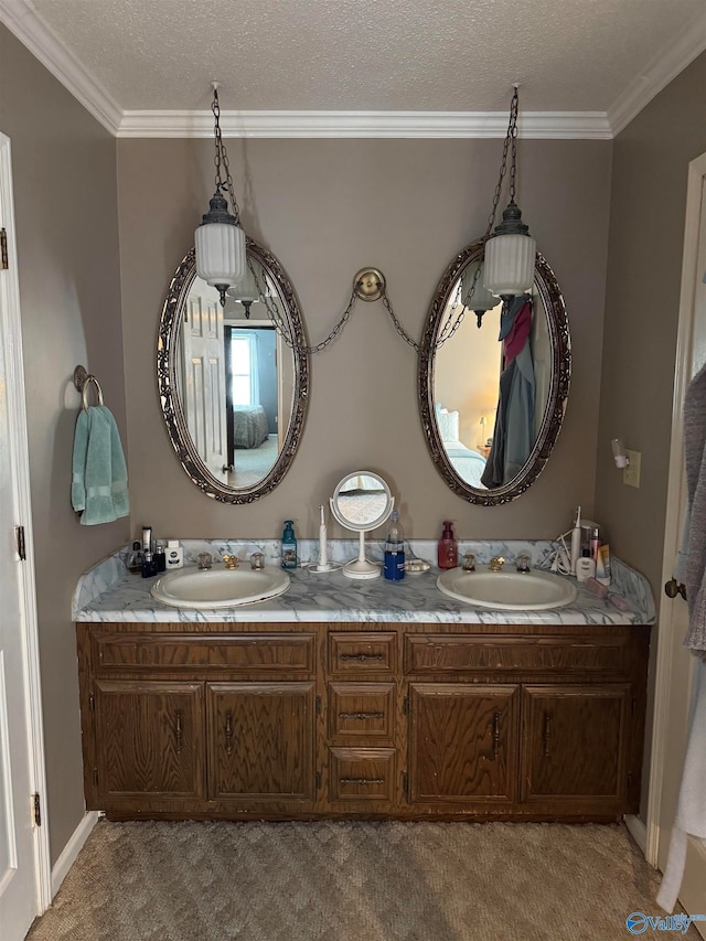 bathroom with vanity, ornamental molding, and a textured ceiling