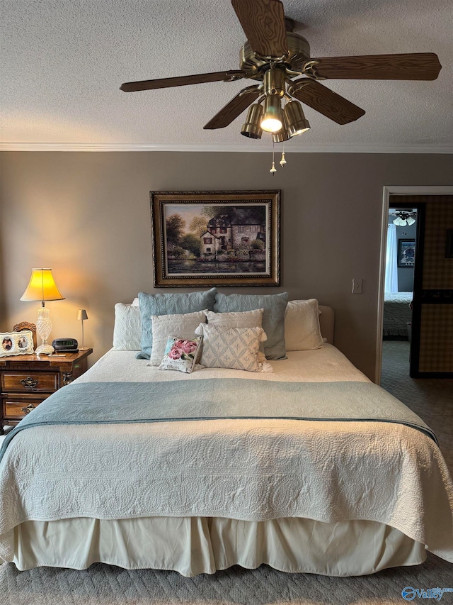 carpeted bedroom featuring a textured ceiling, ceiling fan, and ornamental molding