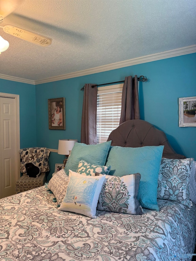 bedroom featuring ornamental molding and a textured ceiling