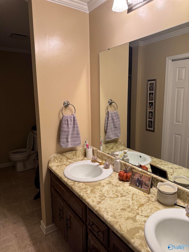 bathroom with crown molding, tile patterned flooring, vanity, and toilet