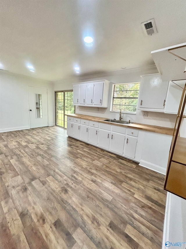 kitchen featuring sink, white cabinets, and hardwood / wood-style flooring