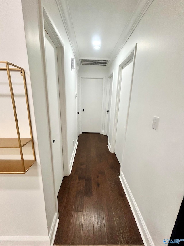 corridor with crown molding and dark hardwood / wood-style flooring