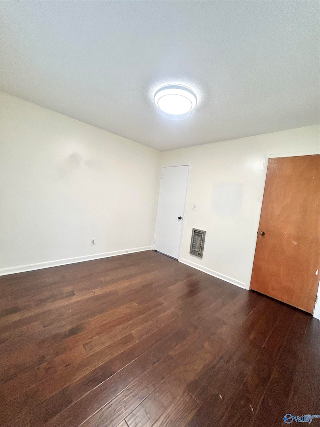 empty room featuring dark wood-type flooring