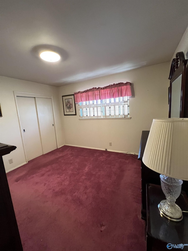 unfurnished room featuring dark carpet