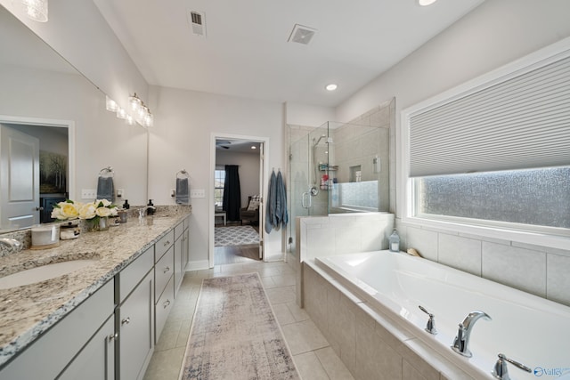 bathroom with tile patterned flooring, vanity, and independent shower and bath