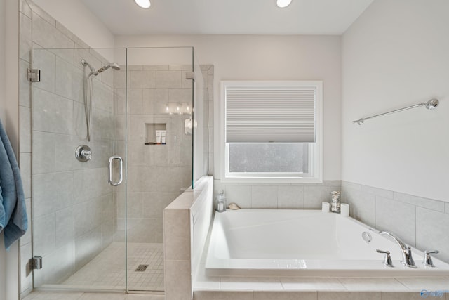 bathroom featuring separate shower and tub