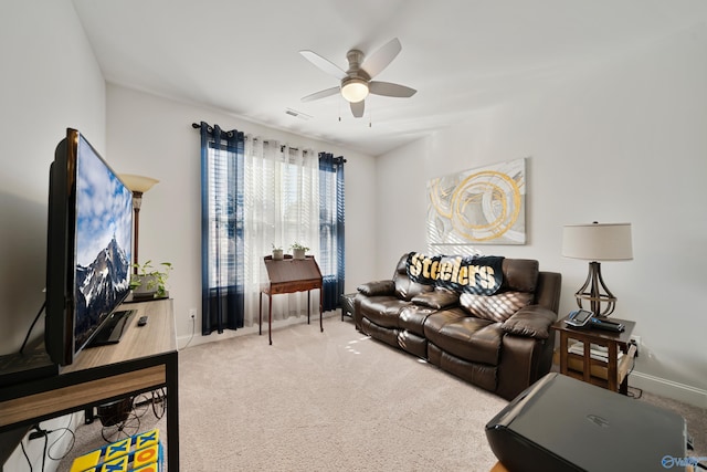 carpeted living room featuring ceiling fan