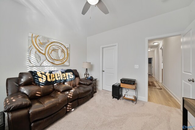 living room featuring ceiling fan and light carpet