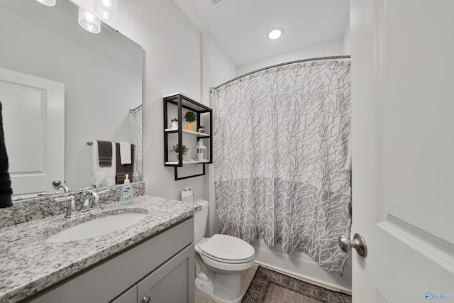 full bathroom featuring vanity, shower / bath combination with curtain, and toilet