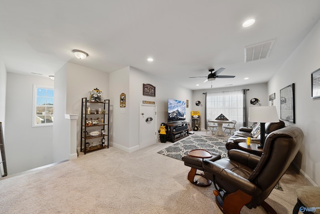 living room featuring light colored carpet and ceiling fan