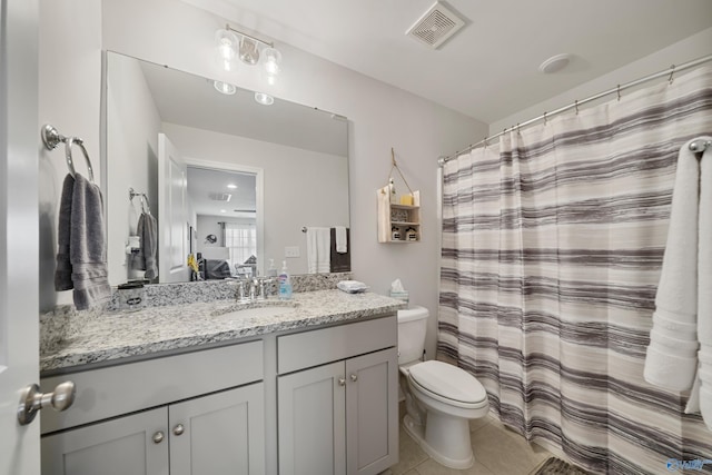 bathroom with curtained shower, tile patterned flooring, vanity, and toilet