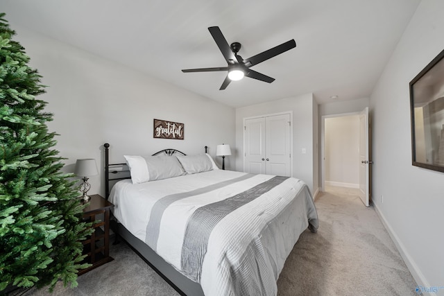 bedroom with light carpet, a closet, and ceiling fan