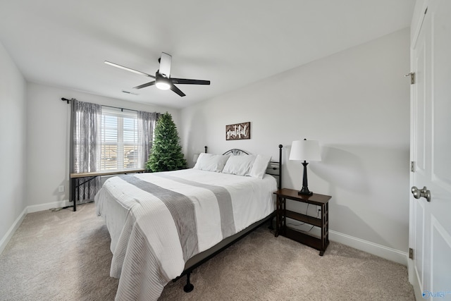 bedroom with ceiling fan and light carpet