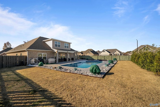 view of swimming pool with a patio area and a yard