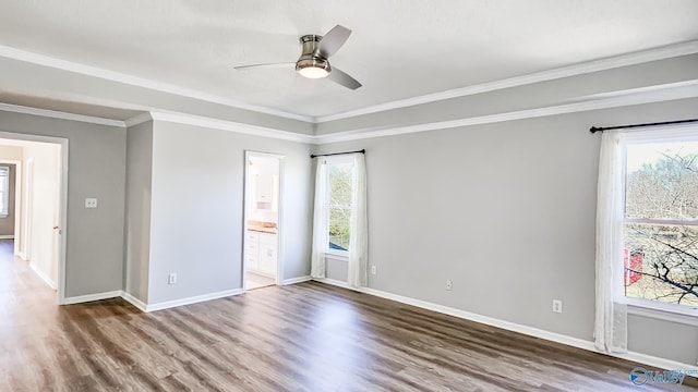 unfurnished bedroom with wood-type flooring, ornamental molding, ceiling fan, and ensuite bathroom