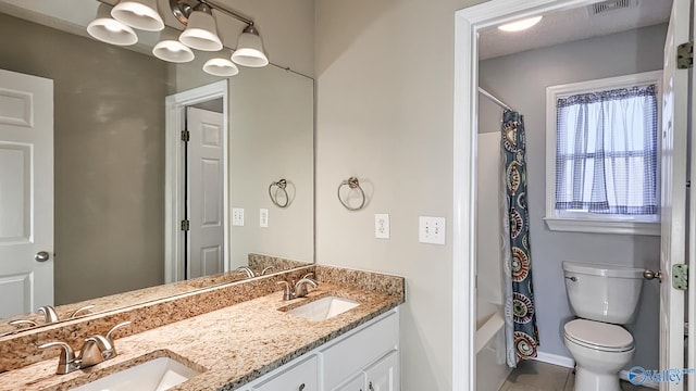 full bathroom featuring shower / tub combo with curtain, vanity, and toilet