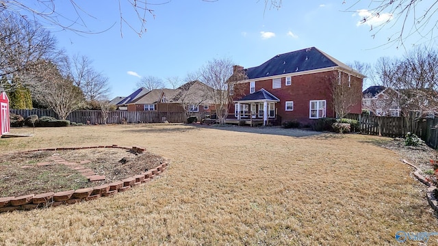 back of house with a lawn