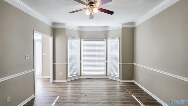 empty room with crown molding, dark hardwood / wood-style floors, ceiling fan, and a textured ceiling