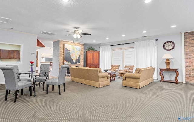 living room featuring ceiling fan, carpet floors, crown molding, and a textured ceiling