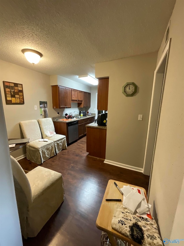 living room with a textured ceiling, dark hardwood / wood-style floors, and sink