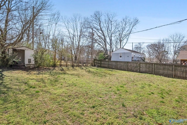 view of yard with an outbuilding and fence