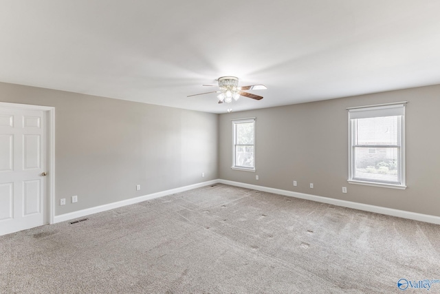 empty room with ceiling fan and carpet flooring