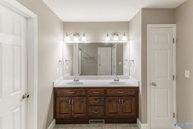 bathroom with tile patterned floors and double sink vanity