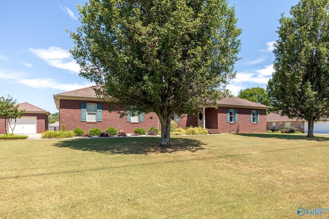 138 Singletree Dr, Hazel Green, AL 35750 - ranch-style house featuring brick siding, an outdoor structure, and a front lawn